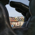 Bristol houses viewed through the Green Hand Of A River God sculpture on Baltic Wharf